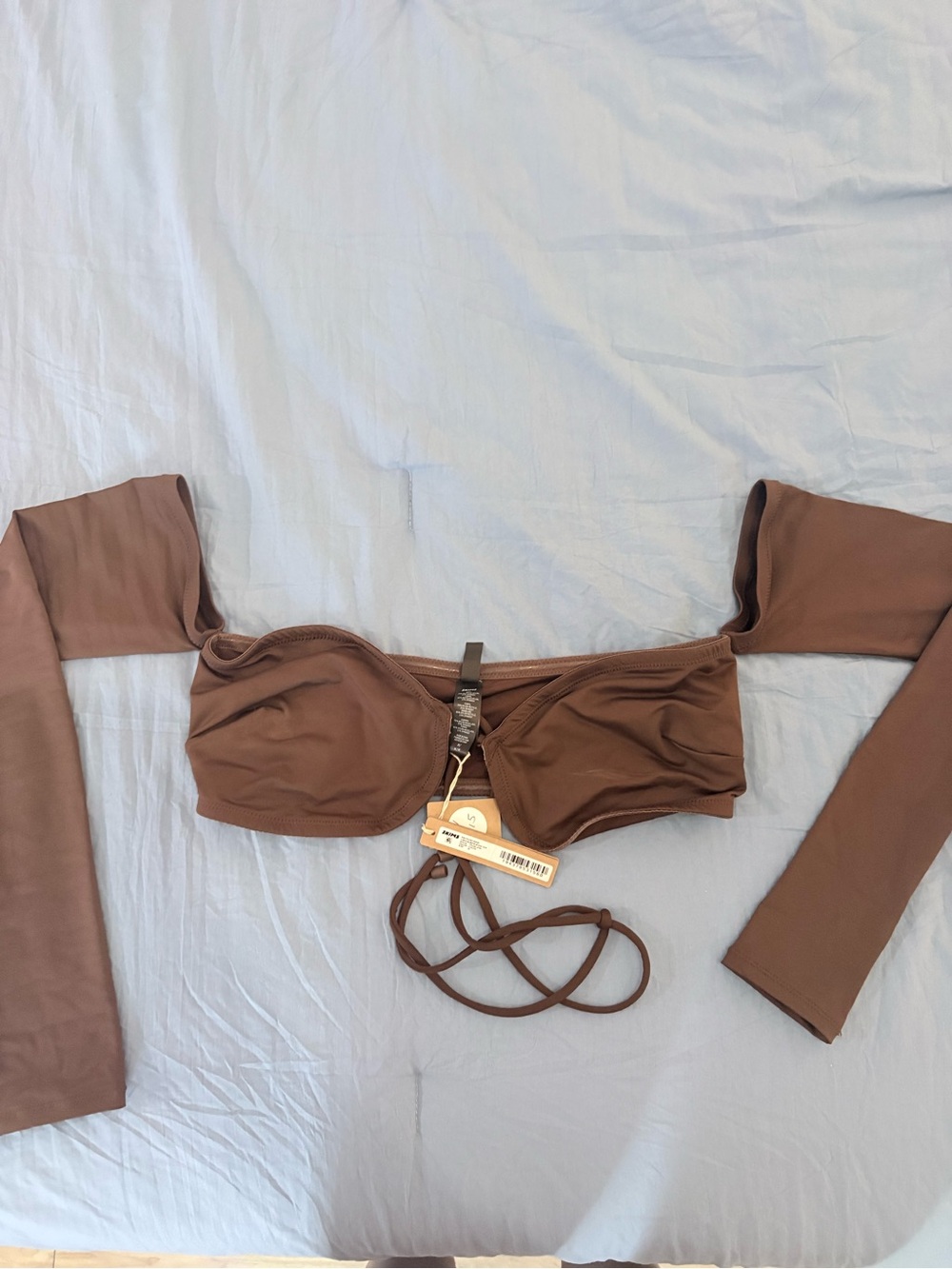 Women’s SKIMS long sleeve bikini top, color is cocoa size medium NWT
